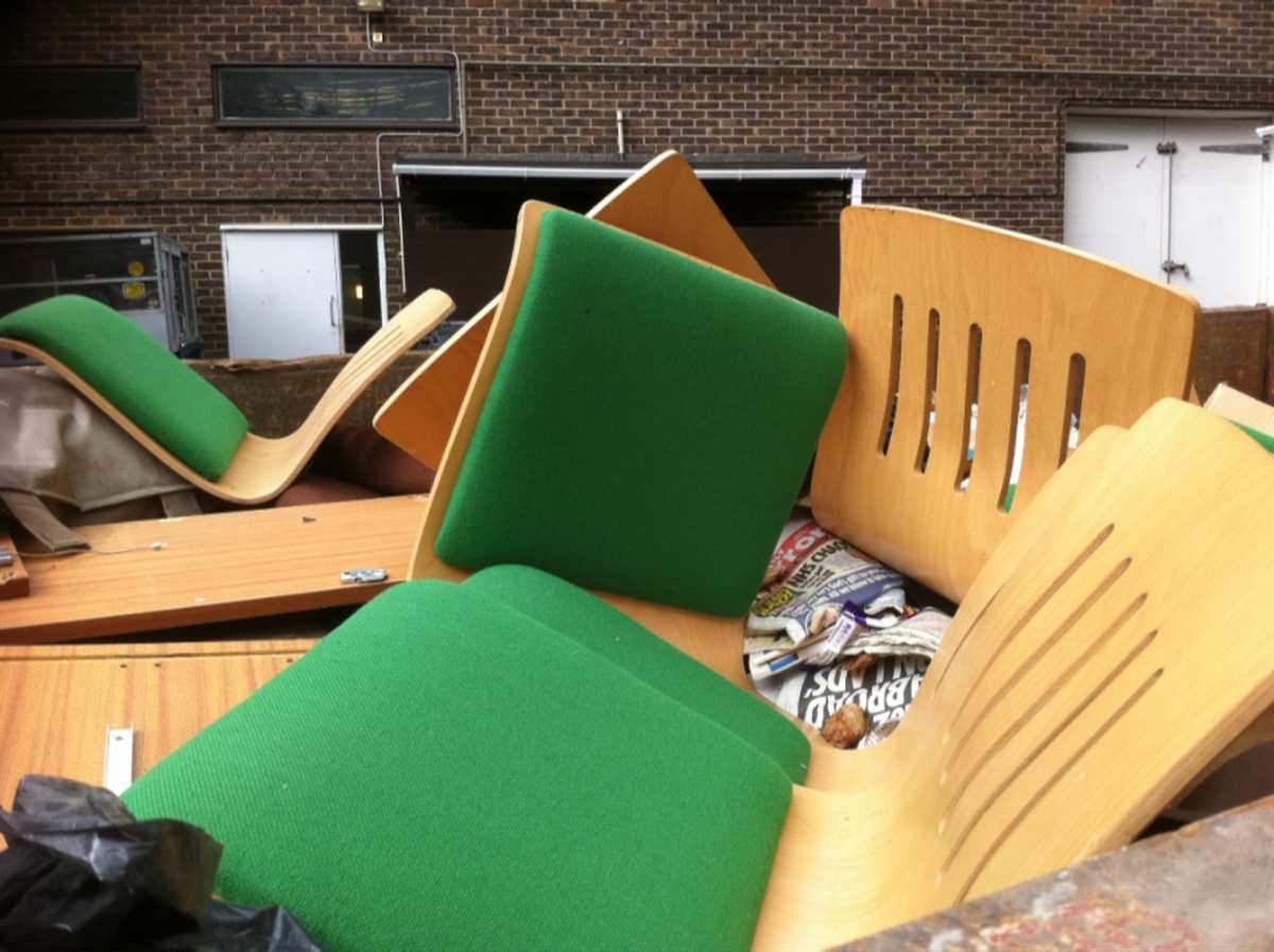 chairs in a skip dumpster